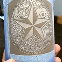 Blasted piece of a design on a cup